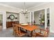 Spacious dining area with a rustic wood table, upholstered chairs, and an ornate chandelier at 21 Barksdale Ne Dr, Atlanta, GA 30309