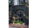 Unique black brick exterior with sculpted stone detail, garden, and stairway at 21 Barksdale Ne Dr, Atlanta, GA 30309