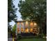 Elegant exterior of home featuring a well-manicured lawn, mature trees, and large windows at 21 Barksdale Ne Dr, Atlanta, GA 30309
