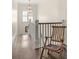 Hallway with hardwood floors, white railings, and a decorative chair at 21 Barksdale Ne Dr, Atlanta, GA 30309