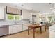 Bright kitchen with white cabinetry, stainless steel appliances, and a center wooden table at 21 Barksdale Ne Dr, Atlanta, GA 30309