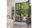 Bright living room featuring glass doors to a covered patio, comfortable furniture, and natural lighting at 21 Barksdale Ne Dr, Atlanta, GA 30309