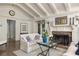Cozy living room with fireplace, hardwood floors, and comfortable seating arrangement with white furniture at 21 Barksdale Ne Dr, Atlanta, GA 30309