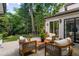 Inviting patio with outdoor seating and views of the manicured gardens and green yard at 21 Barksdale Ne Dr, Atlanta, GA 30309