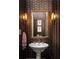Stylish powder room with patterned wallpaper, ornate mirror, and vessel sink at 21 Barksdale Ne Dr, Atlanta, GA 30309
