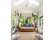 Bright sunroom with vaulted ceiling, potted greenery, and comfortable seating near large windows at 21 Barksdale Ne Dr, Atlanta, GA 30309