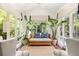 Charming sunroom with ample natural light, potted plants, and comfortable seating arrangement at 21 Barksdale Ne Dr, Atlanta, GA 30309