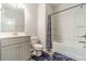 Clean bathroom featuring a shower-tub combo, white vanity, and gray flooring at 2252 Talmai Dr, Snellville, GA 30078