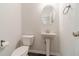 Well-lit half bathroom features a pedestal sink and modern fixtures at 2252 Talmai Dr, Snellville, GA 30078