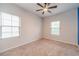 Bedroom with carpeted floors, ceiling fan and two windows at 2252 Talmai Dr, Snellville, GA 30078