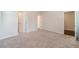 Spacious bedroom with neutral carpet, white trim, and multiple entryways at 2252 Talmai Dr, Snellville, GA 30078