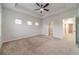 Large primary bedroom with tray ceilings, plush carpet, and ample natural light at 2252 Talmai Dr, Snellville, GA 30078