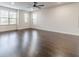 Spacious bedroom featuring a ceiling fan, large windows, and hardwood floors at 2252 Talmai Dr, Snellville, GA 30078