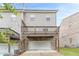 Back view of a townhome, showing the upper-level balconies and two-car garage at 2252 Talmai Dr, Snellville, GA 30078