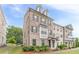 Attractive multi-story townhome with brick facade, dormer windows, and manicured lawn at 2252 Talmai Dr, Snellville, GA 30078