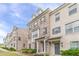Attractive brick townhomes featuring covered entries, neutral brick, and landscaped frontage at 2252 Talmai Dr, Snellville, GA 30078