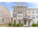 Charming brick townhome featuring a covered entryway, detailed trim, and well-maintained landscaping at 2252 Talmai Dr, Snellville, GA 30078