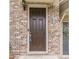 Close-up of a brown front door with brick surround, sidelight and address numbers at 2252 Talmai Dr, Snellville, GA 30078
