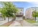 Rear view featuring a two-car garage and wooden deck, with a small backyard at 2252 Talmai Dr, Snellville, GA 30078
