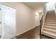 Bright hallway with hardwood floors, staircase, and open doorway to a carpeted room at 2252 Talmai Dr, Snellville, GA 30078
