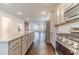 Bright, open kitchen featuring modern appliances, granite countertops, and hardwood floors at 2252 Talmai Dr, Snellville, GA 30078