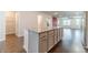 Open concept kitchen with a granite island that transitions to a living area featuring hardwood floors at 2252 Talmai Dr, Snellville, GA 30078