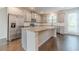 Modern kitchen features stainless steel appliances, granite countertops, and a large central island at 2252 Talmai Dr, Snellville, GA 30078
