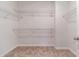 Spacious walk-in closet featuring carpeted floors and white wire shelving at 2252 Talmai Dr, Snellville, GA 30078