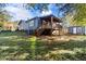 Backyard view with a home with covered porch, back steps and a small shed at 389 Oglesby Bridge Se Rd, Conyers, GA 30094