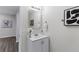 Clean, modern bathroom with white vanity, contemporary mirror, and neutral decor at 389 Oglesby Bridge Se Rd, Conyers, GA 30094