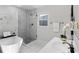 Elegant bathroom with a sleek soaking tub and glass-enclosed shower at 389 Oglesby Bridge Se Rd, Conyers, GA 30094