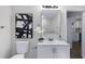 Well-lit bathroom with elegant vanity and decorative artwork at 389 Oglesby Bridge Se Rd, Conyers, GA 30094