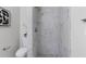 Sleek bathroom featuring a walk-in shower with marble-patterned tiles and stone flooring at 389 Oglesby Bridge Se Rd, Conyers, GA 30094