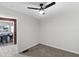 Cozy bedroom featuring carpet flooring, a ceiling fan, and an open doorway to the dining room at 389 Oglesby Bridge Se Rd, Conyers, GA 30094