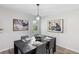 Chic dining room with modern table setting, stylish light fixture, and contemporary artwork at 389 Oglesby Bridge Se Rd, Conyers, GA 30094