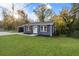 Exterior view of a charming home with well-maintained lawn at 389 Oglesby Bridge Se Rd, Conyers, GA 30094