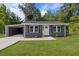 Charming gray home with a well-manicured lawn and a convenient carport at 389 Oglesby Bridge Se Rd, Conyers, GA 30094