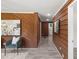 Hallway with wood paneling and modern gray floors, offering a glimpse into other rooms at 389 Oglesby Bridge Se Rd, Conyers, GA 30094