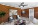Cozy living room featuring wood paneled walls, stylish seating, and contemporary decor at 389 Oglesby Bridge Se Rd, Conyers, GA 30094