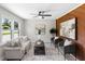 Bright and airy living room with a sofa, stylish armchairs, and wood-paneled accent wall at 389 Oglesby Bridge Se Rd, Conyers, GA 30094