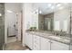 Bathroom featuring double sinks with granite countertops and a tiled shower at 612 Concord Lake Se Cir, Smyrna, GA 30082