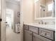Bathroom vanity features gray cabinets, drawers, and a white countertop, complemented by a white framed mirror at 612 Concord Lake Se Cir, Smyrna, GA 30082