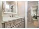Bathroom vanity features gray cabinets, drawers, and a white countertop, complemented by a white framed mirror at 612 Concord Lake Se Cir, Smyrna, GA 30082