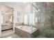Luxurious bathroom featuring a soaking tub and glass shower with access to the bedroom at 612 Concord Lake Se Cir, Smyrna, GA 30082