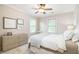 Bright bedroom with ceiling fan, large windows, and neutral tones offers a peaceful retreat at 612 Concord Lake Se Cir, Smyrna, GA 30082