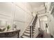Bright foyer with a grand staircase and upper landing showcases the home's open and airy design at 612 Concord Lake Se Cir, Smyrna, GA 30082