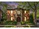 Beautiful exterior featuring brick, stone, a Juliette balcony, and manicured landscaping at 612 Concord Lake Se Cir, Smyrna, GA 30082