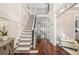 Bright foyer showcasing an open staircase, hardwood floors, and elegant trim at 612 Concord Lake Se Cir, Smyrna, GA 30082