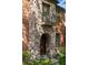 Close-up of the home's stone facade, arched entry and dark wood door and balcony at 612 Concord Lake Se Cir, Smyrna, GA 30082