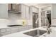 Modern kitchen featuring white cabinets, stainless steel appliances, and a quartz countertop at 612 Concord Lake Se Cir, Smyrna, GA 30082